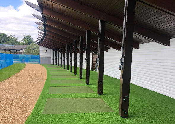 Asheville Covered outdoor tee line with light green synthetic grass boxes inside a dark green synthetic grass strip